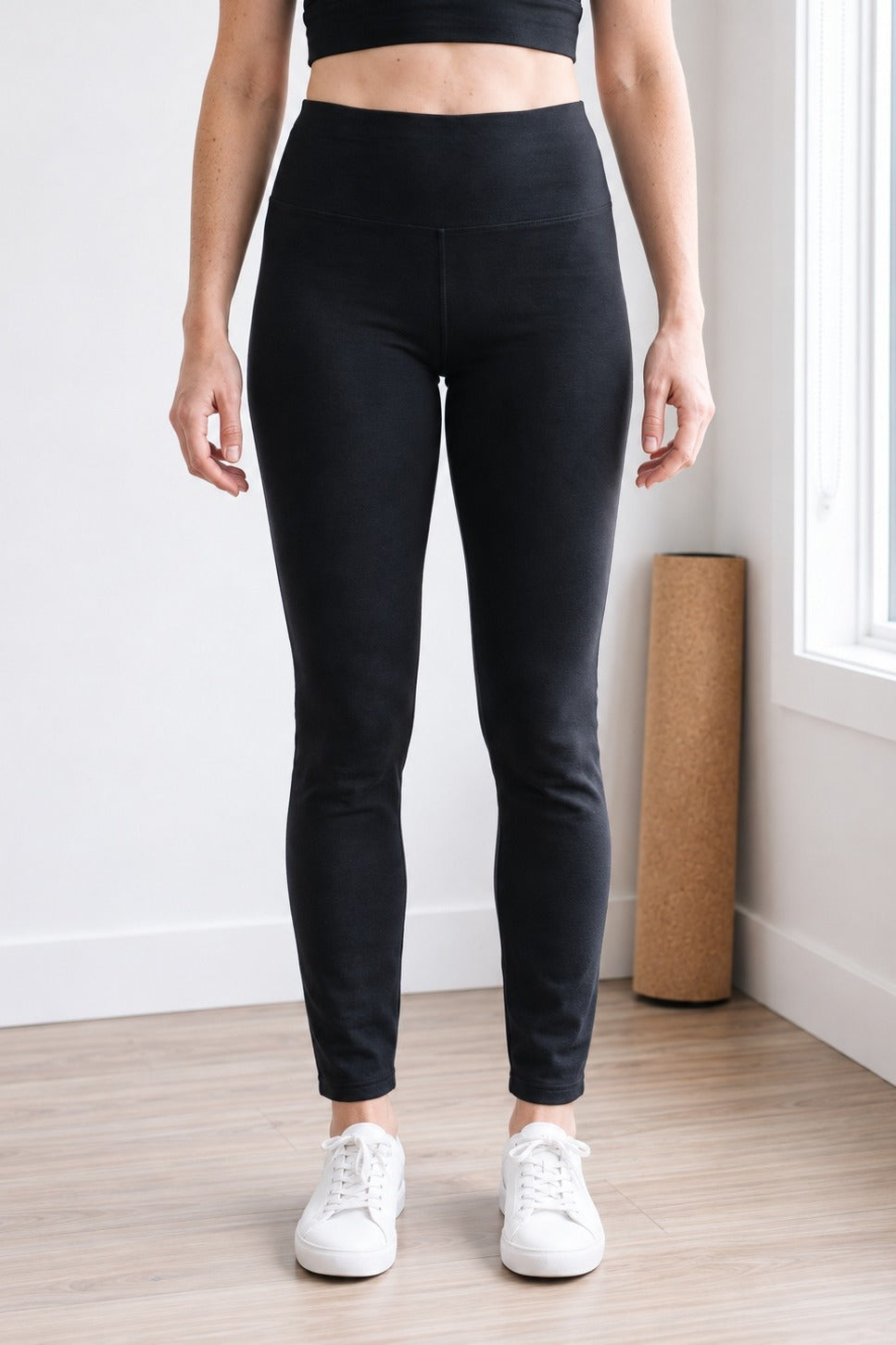 Front view of black organic cotton leggings with 30" inseam hitting at the ankle, high-rise waistband