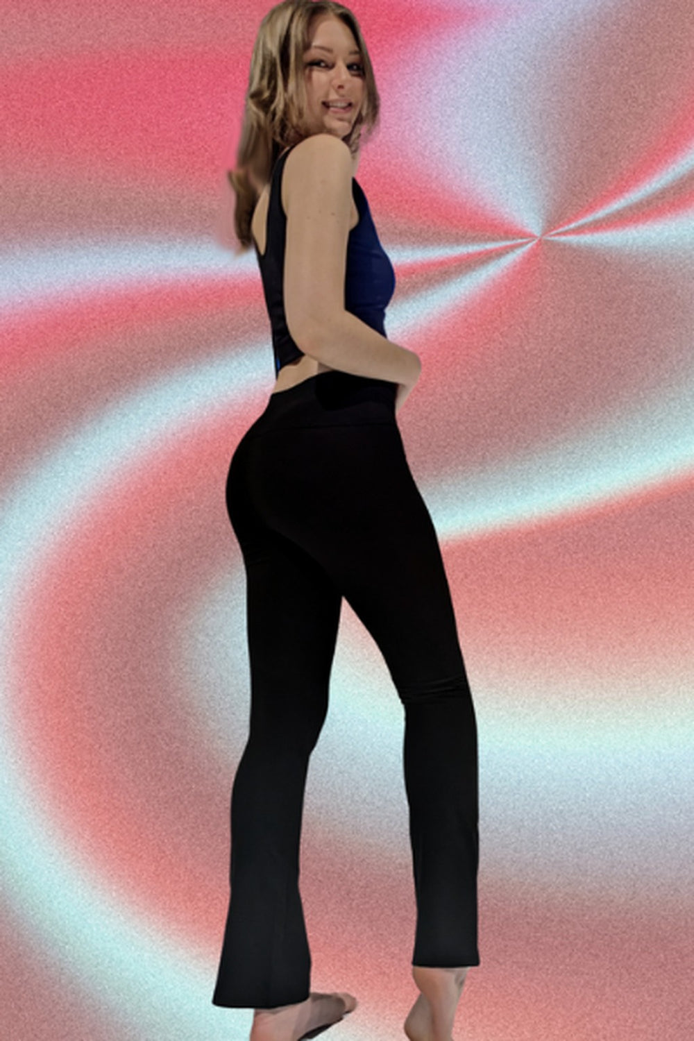 Woman wearing black organic cotton mini flare yoga pants 28", back view
