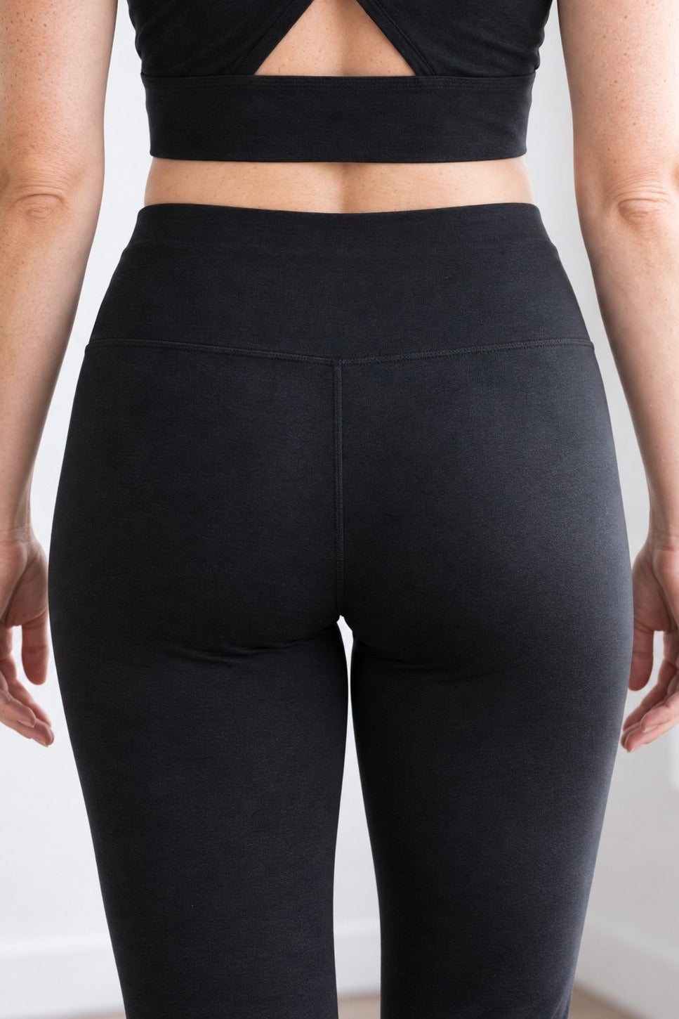 Back close-up of black organic cotton leggings 30" showing seat fit and smooth opaque cotton fabric
