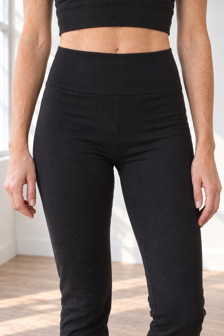 Close-up of the wide, soft rounded high-rise waistband on black organic cotton leggings