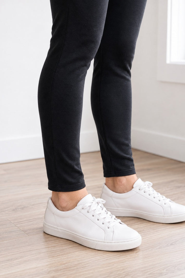 Close-up of the hem of 27" organic cotton leggings hitting right at the ankle over white sneakers