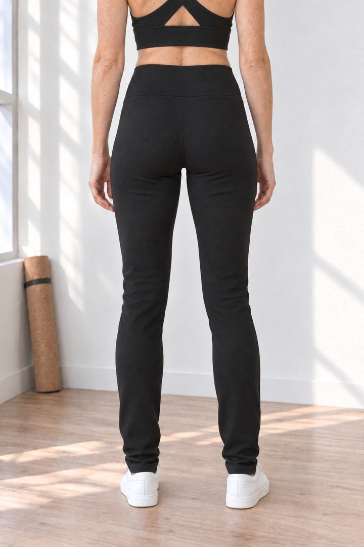 Back view of tall black organic cotton leggings 33" inseam, full length to the ankle, with crisscross back tank top